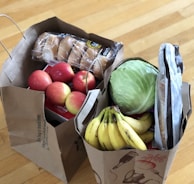 apples and bananas in brown cardboard box