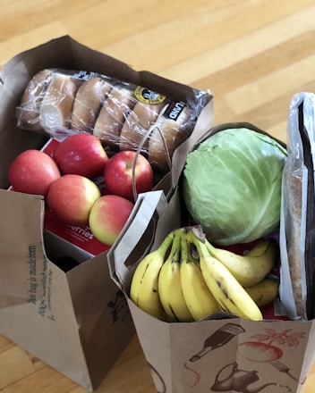 apples and bananas in brown cardboard box