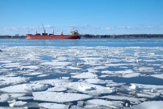 red and white boat on sea during daytime in Québec Canada