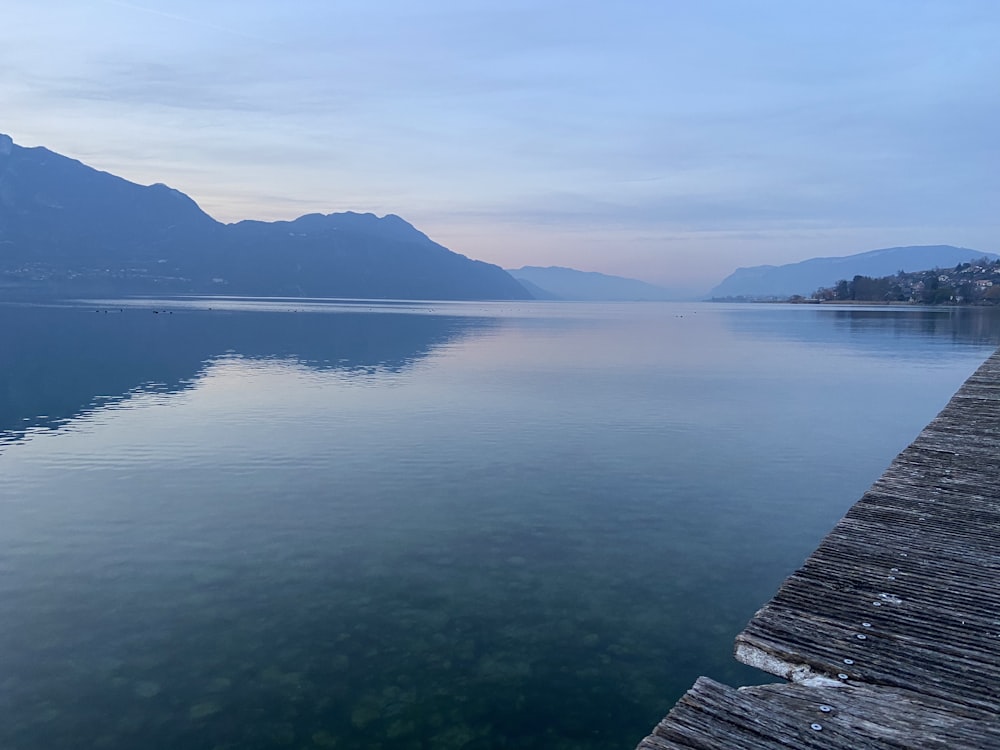 body of water near mountain during daytime