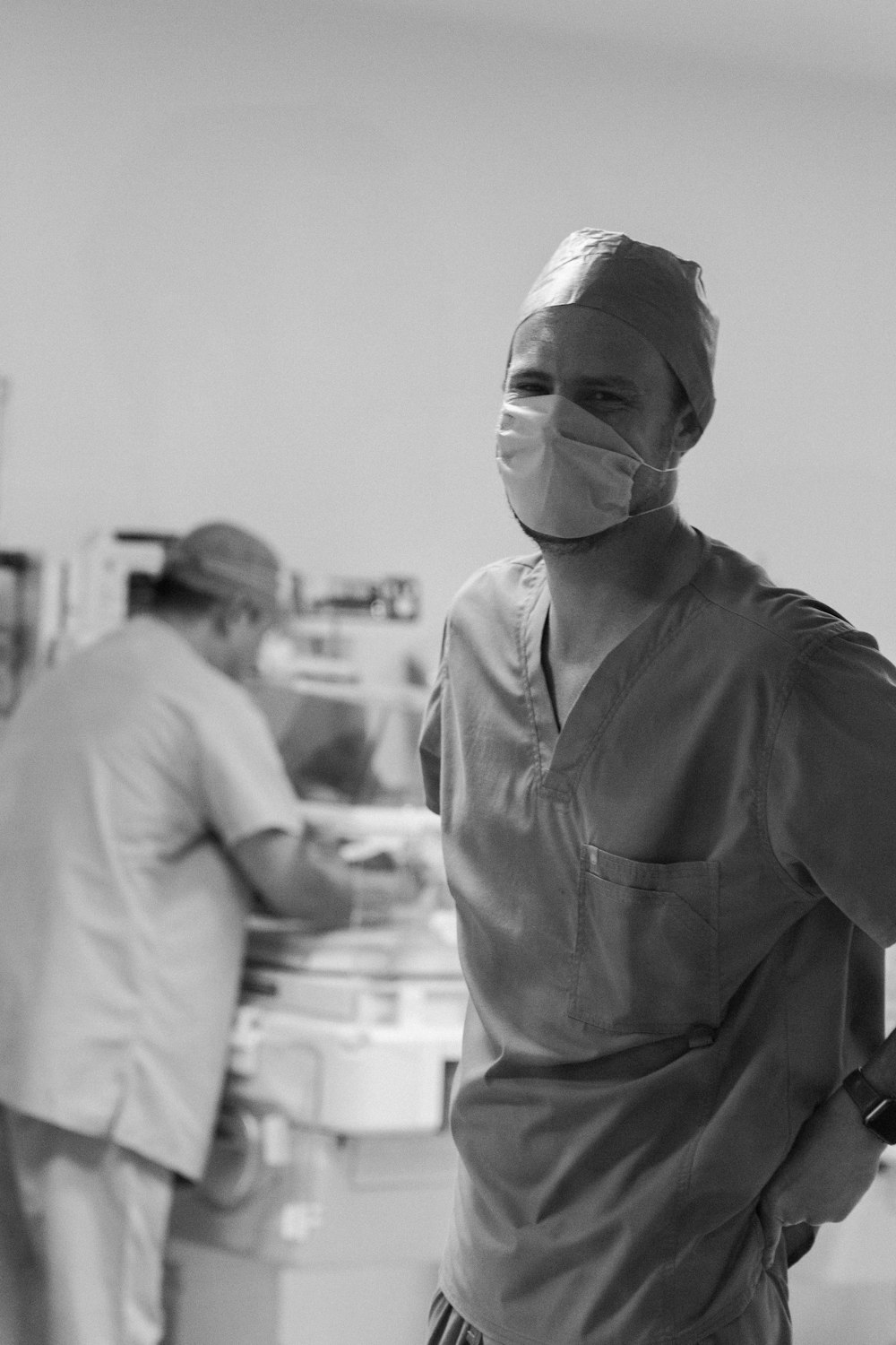 grayscale photo of woman in scrub suit