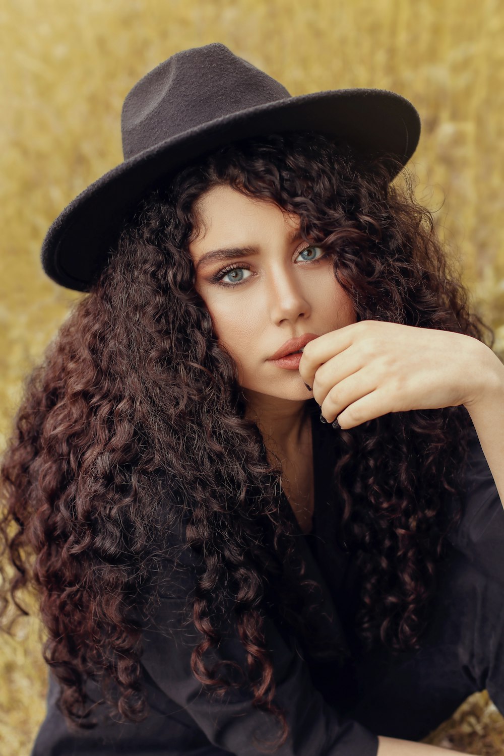 woman in black hat and black long sleeve shirt
