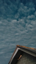 brown and white concrete building under blue sky