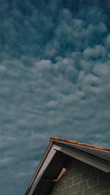 brown and white concrete building under blue sky