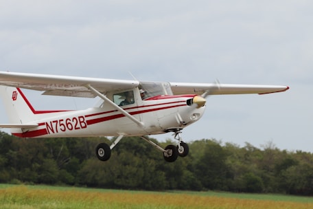 white and red airplane on mid air during daytime