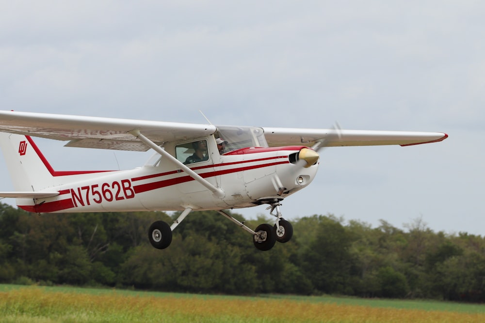 white and red airplane on mid air during daytime