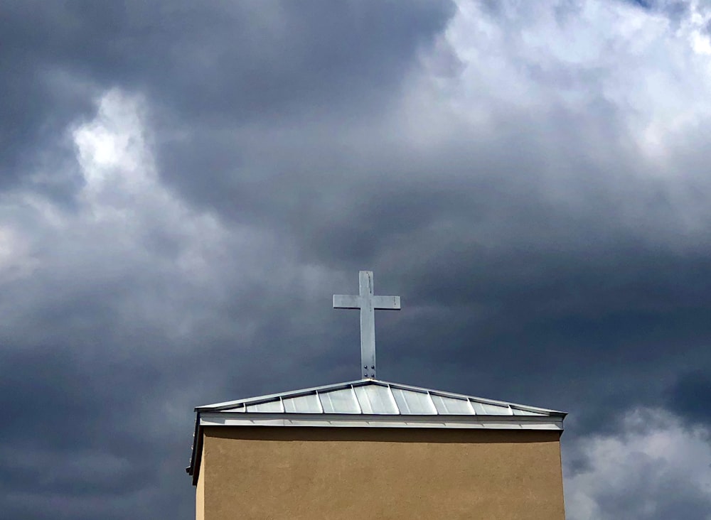 brown and white concrete building under gray clouds