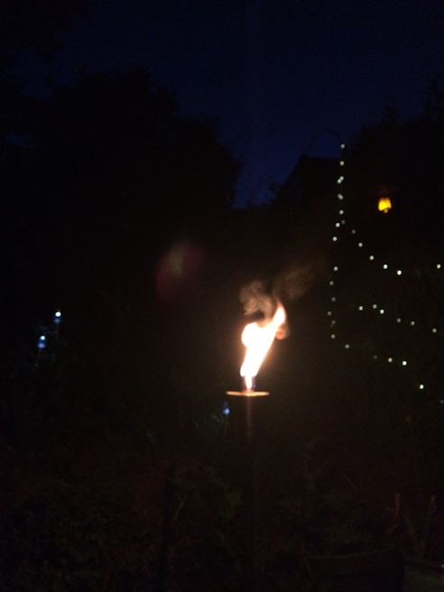 A rechargeable kisan torch illuminating a rustic outdoor setting at dusk