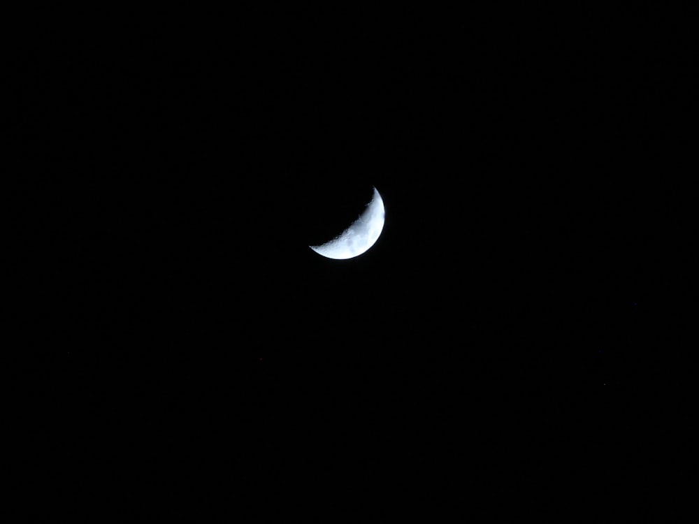 white crescent moon in the sky