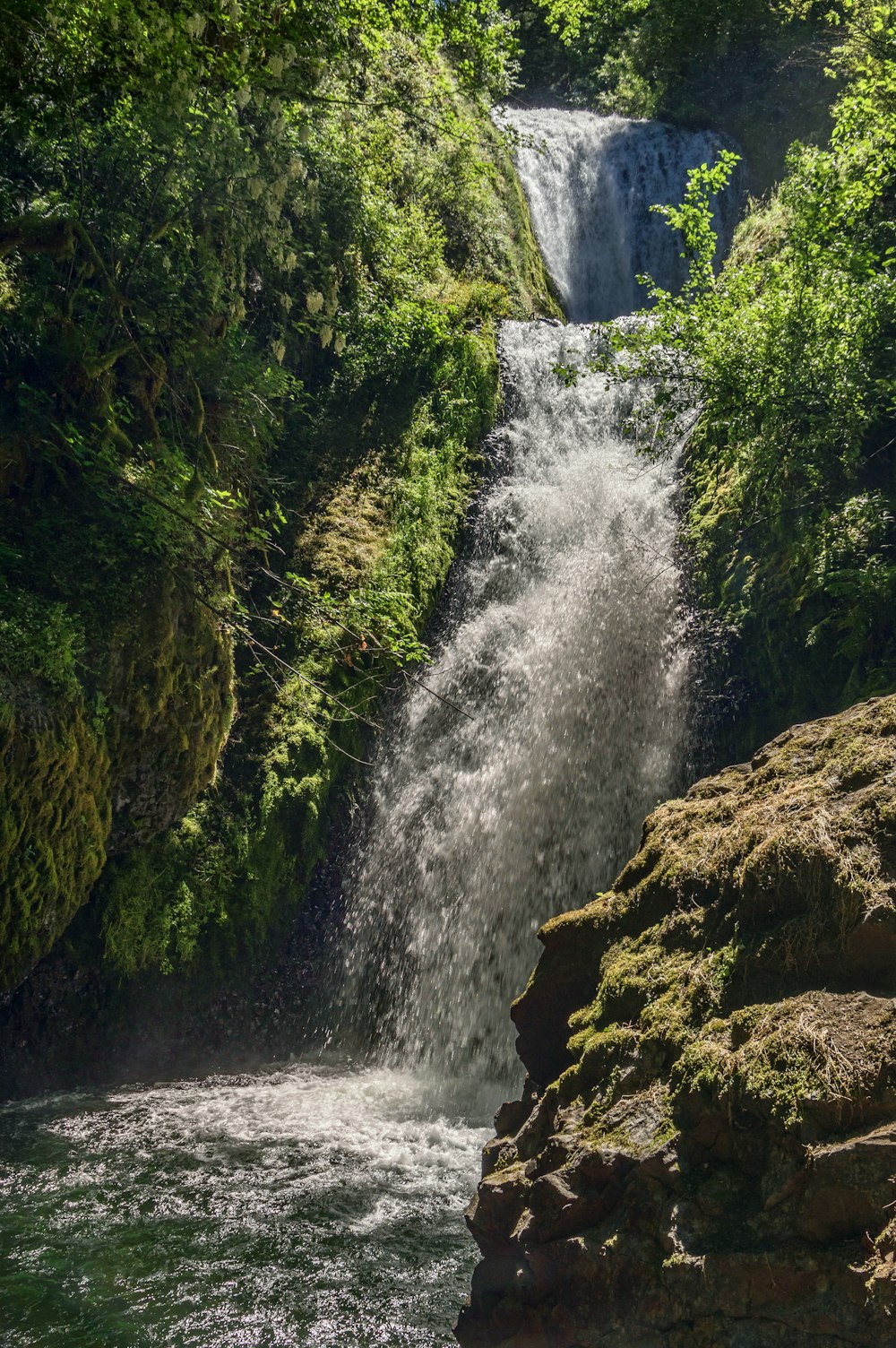 water falls on brown rock