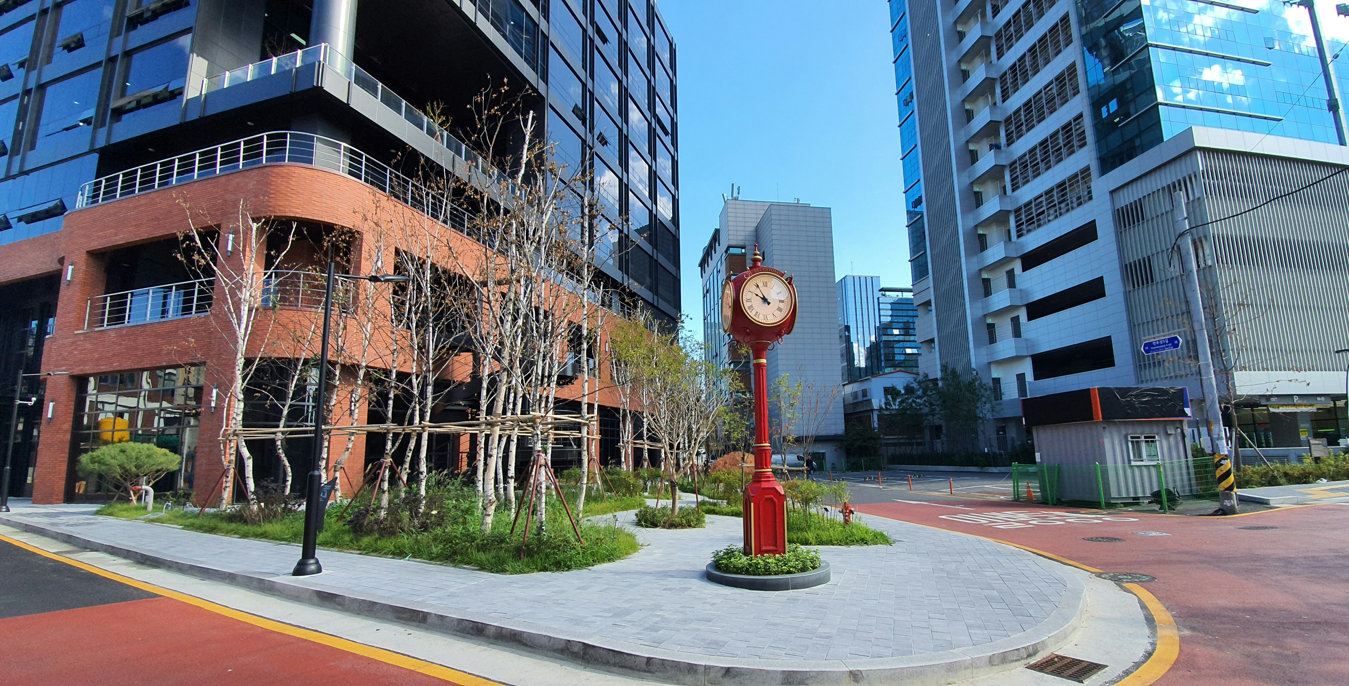 red and white street lamp near brown concrete building during daytime