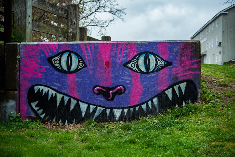 purple and black graffiti on wall