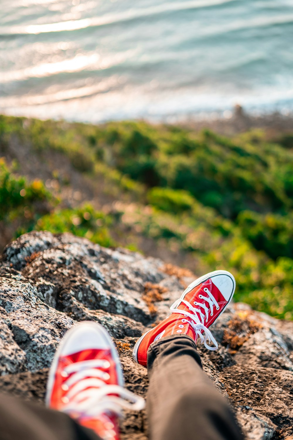 person wearing red and white sneakers