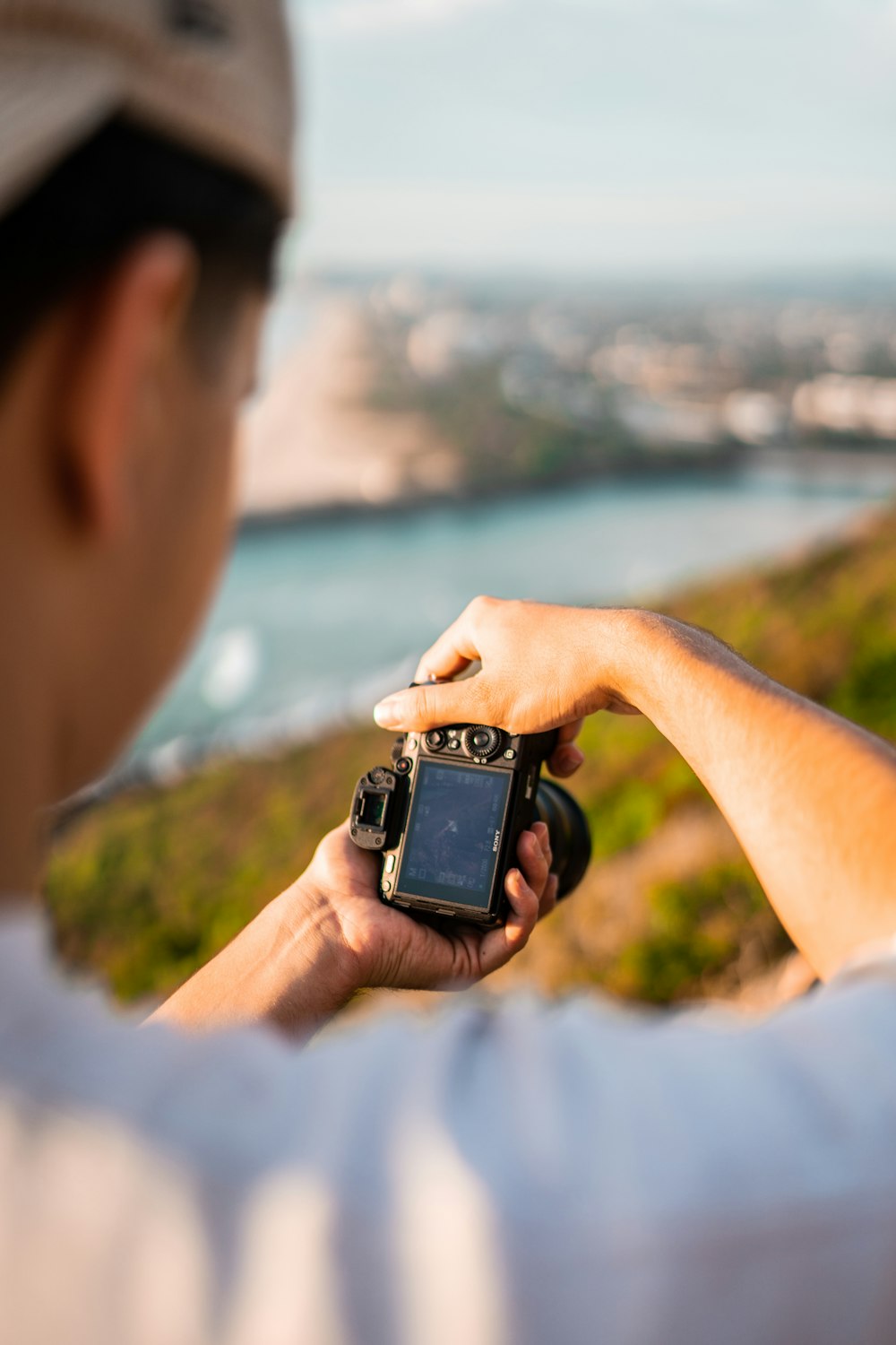 person holding black and silver camera