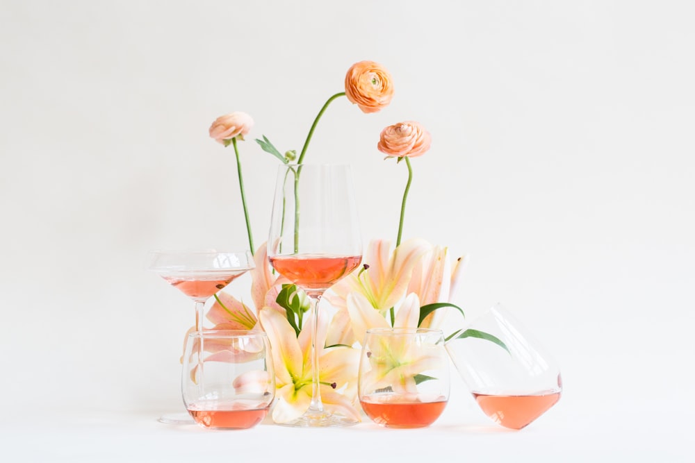 white and orange flowers in clear glass vase