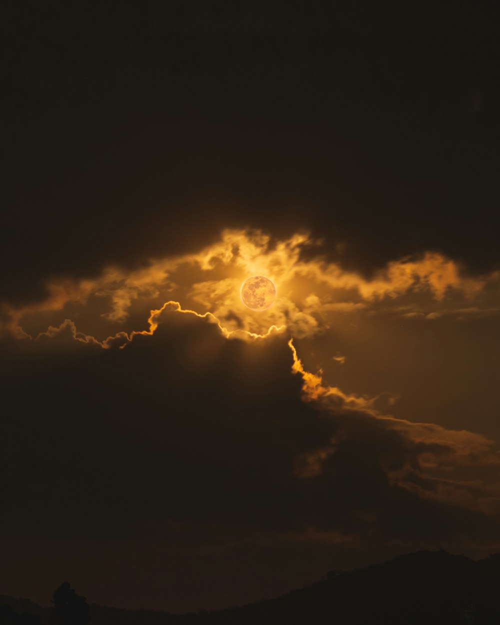 sun covered by clouds during night time