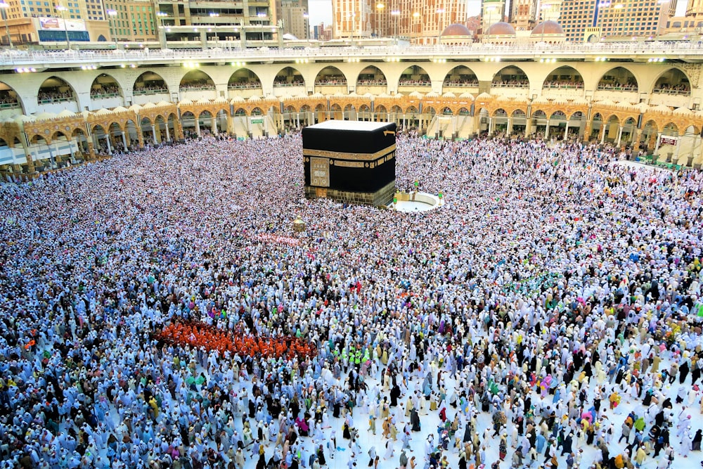 a large group of people standing around a kabab