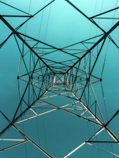 black metal electric tower under blue sky during daytime
