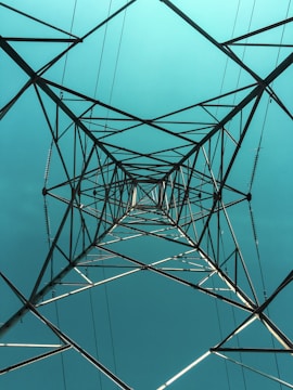black metal electric tower under blue sky during daytime