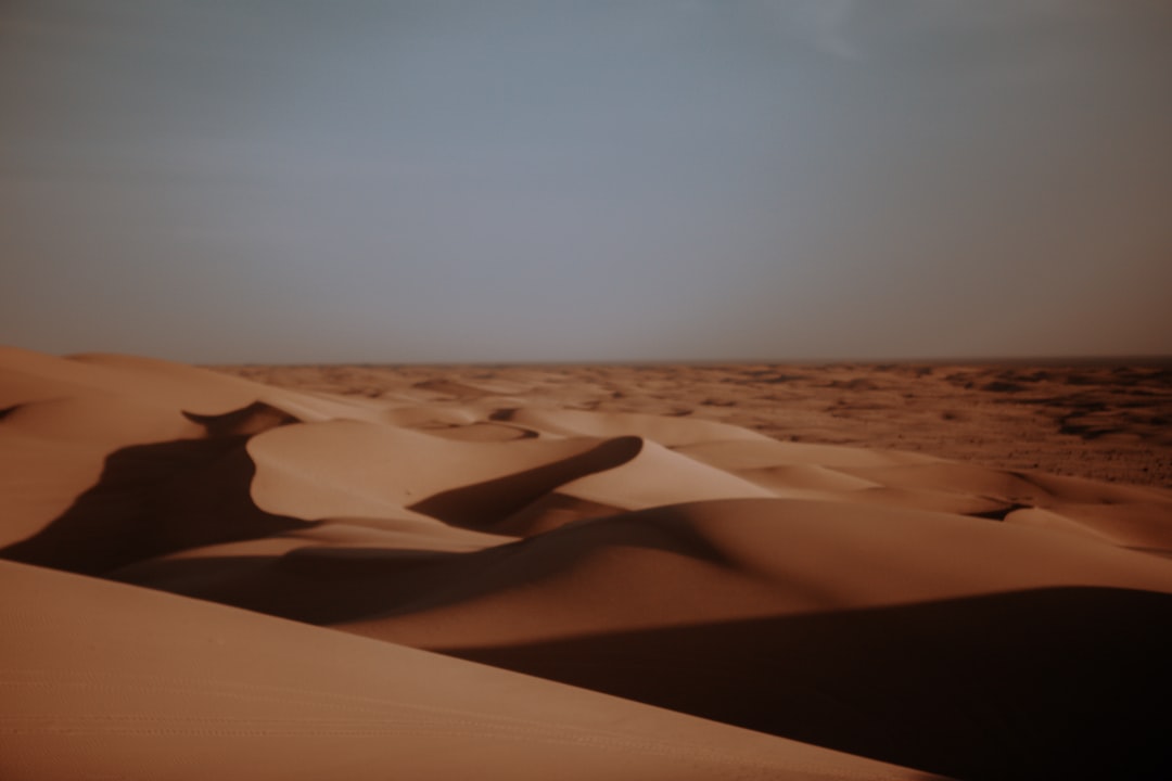 brown sand under white sky during daytime