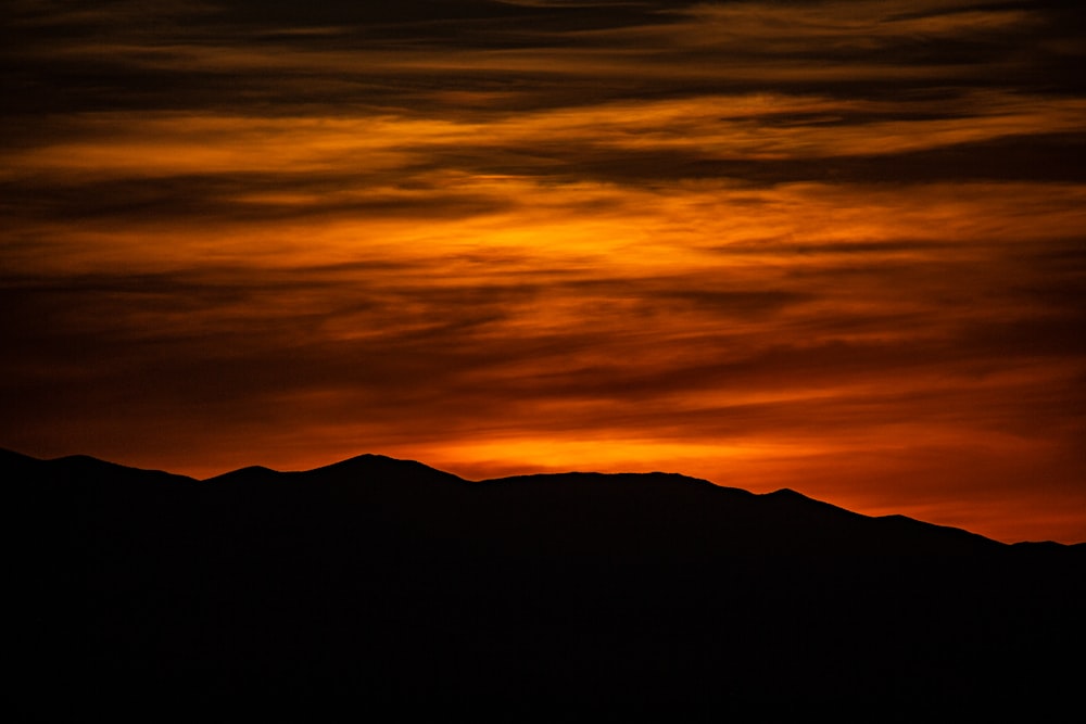 silhouette of mountain during sunset