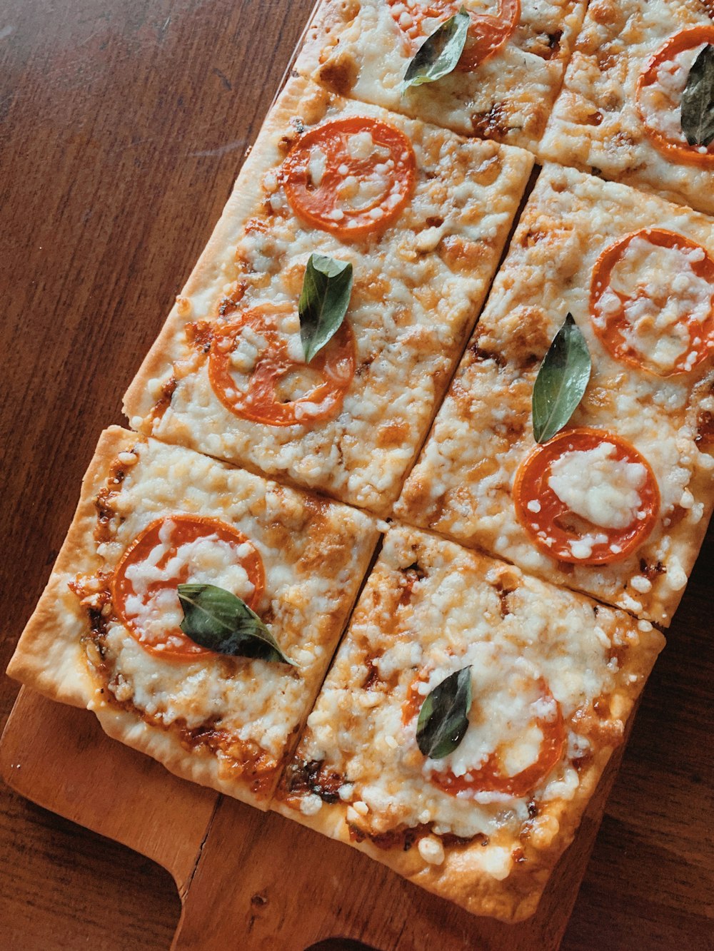 pizza with green leaves on top