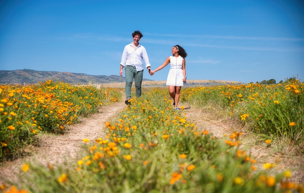 couple walking on green grass field during daytime