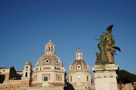 white concrete building under blue sky during daytime in Piazza Venezia Italy