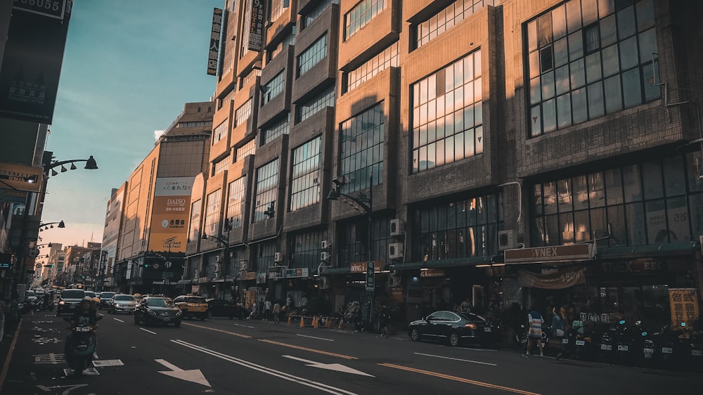 cars parked beside brown building during daytime