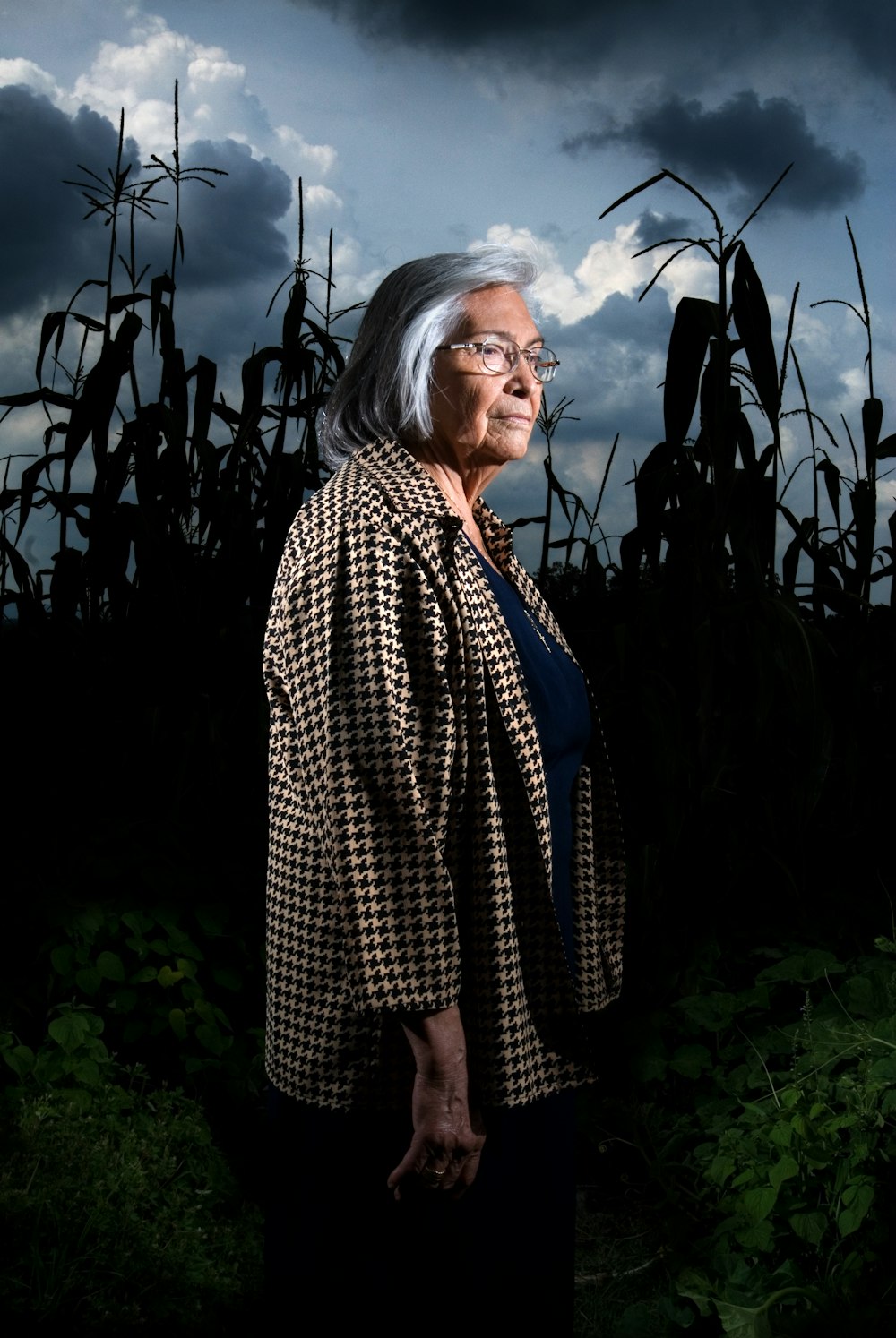 woman in black and white long sleeve shirt standing near green plants during daytime