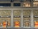 A luxury storefront with a lavish gold-accented facade, featuring prominent branding of the name 'BVLGARI'. The store displays have illuminated windows showcasing products, with elegant design and decor elements. The overall aesthetic conveys sophistication and opulence.