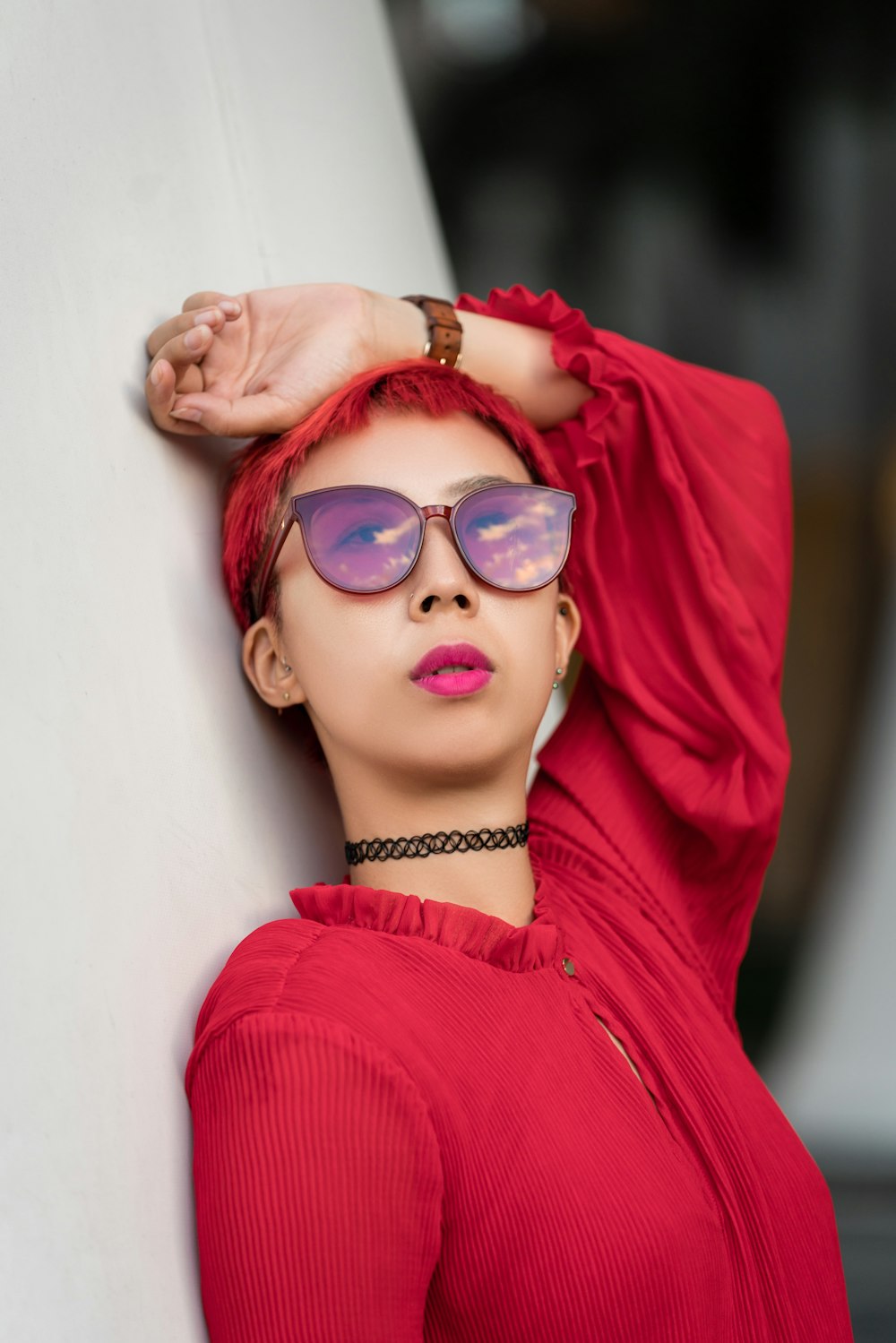 woman in red long sleeve shirt wearing blue framed sunglasses