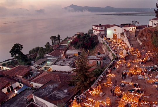 aerial view of city near body of water during daytime in Janitzio Mexico