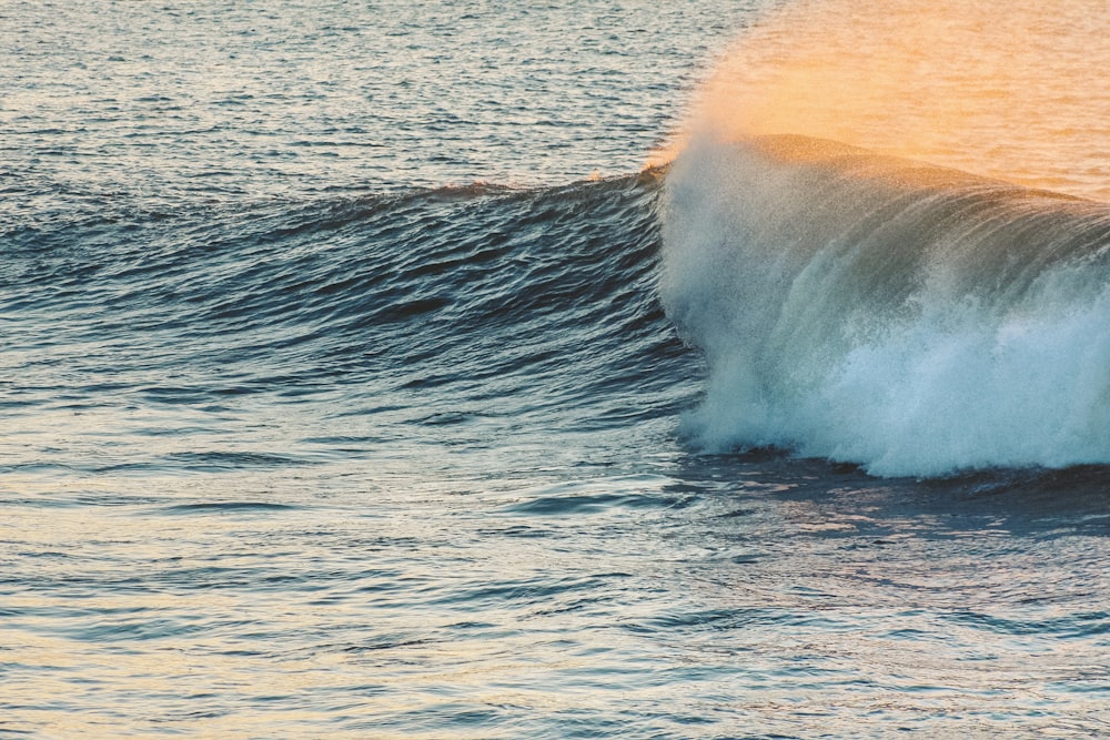 ocean waves crashing on shore during daytime