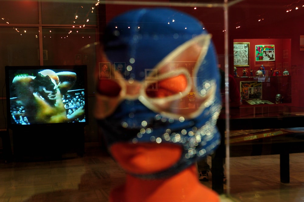 person holding blue and orange glass