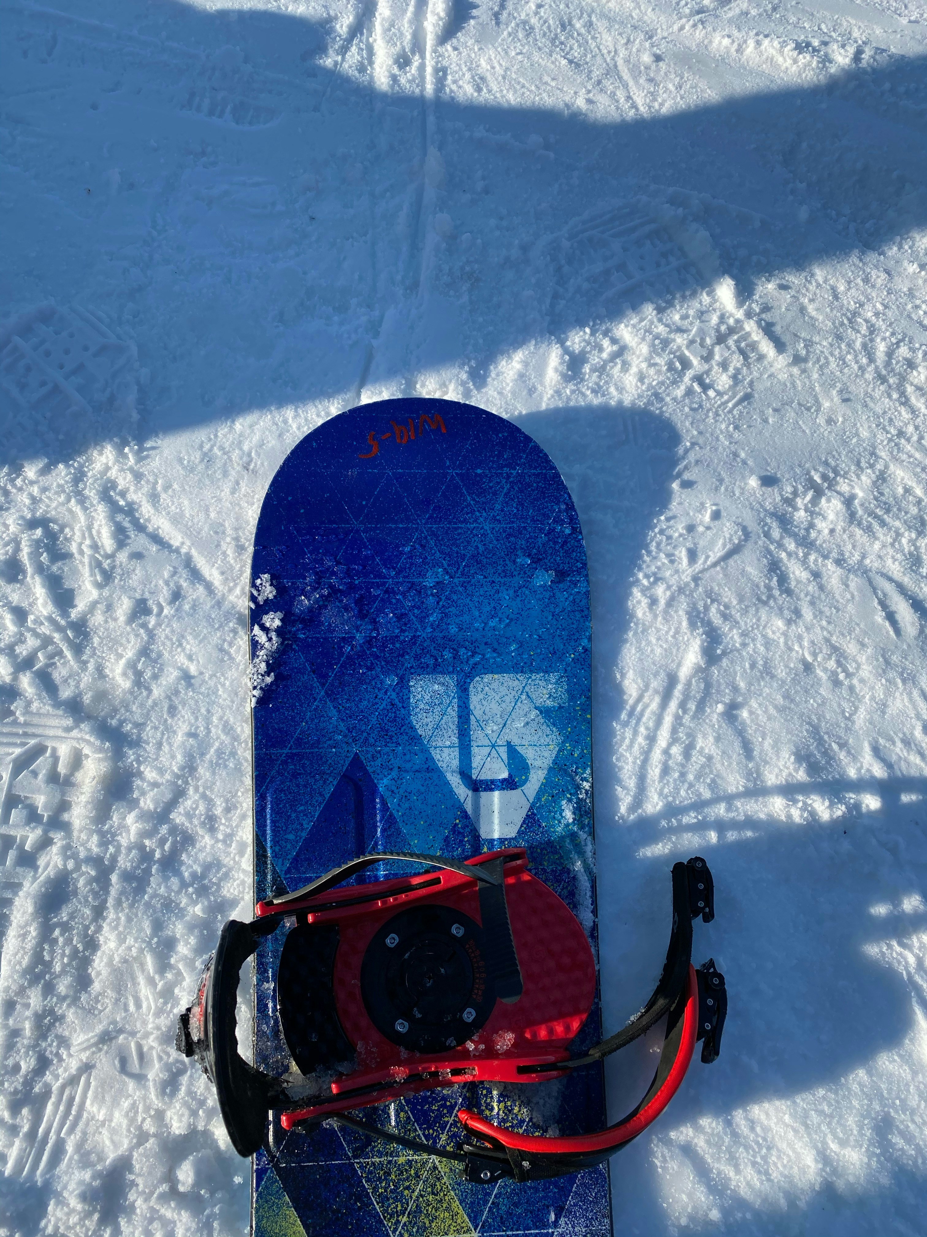 Red and black snow sled on snow covered ground photo Free Blue Image