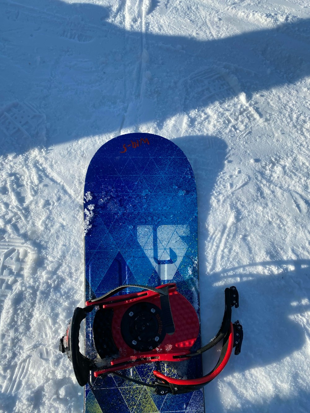 red and black snow sled on snow covered ground