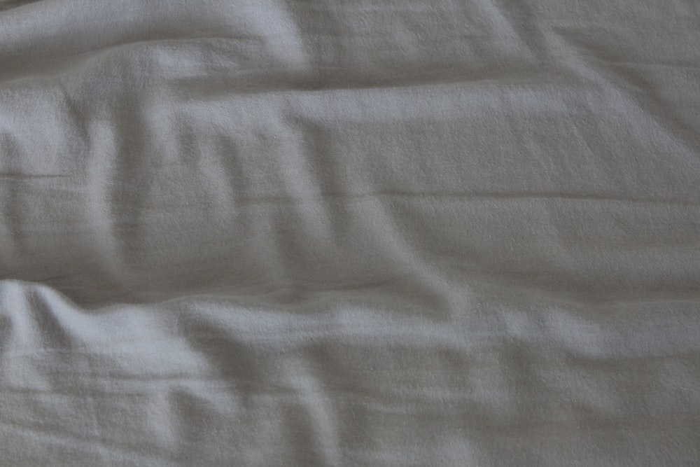 white textile on brown wooden table