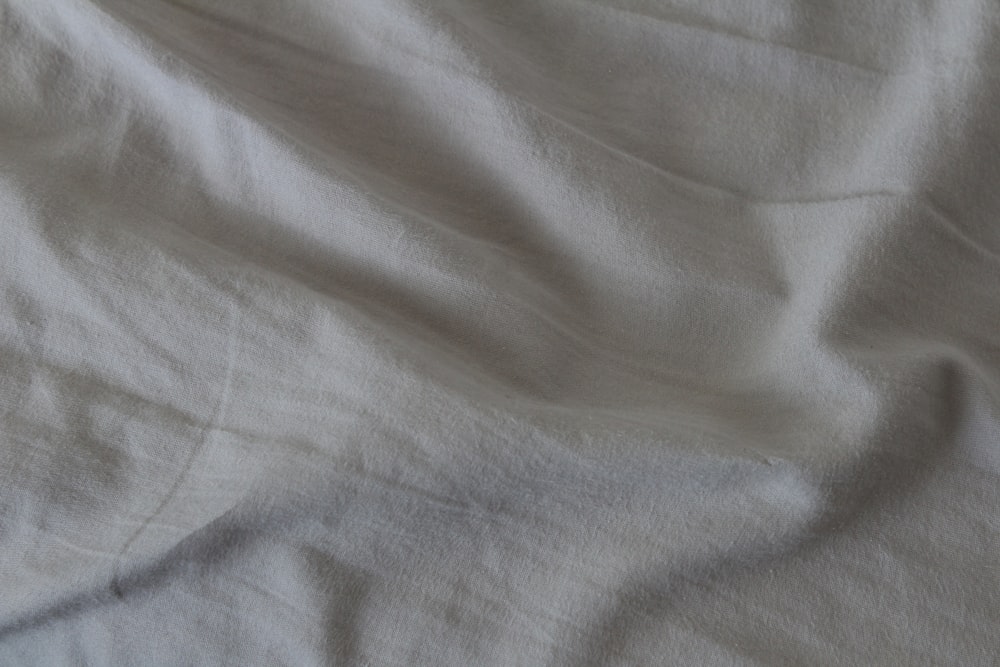 white textile on blue textile