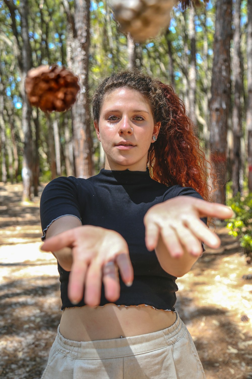 woman in black long sleeve shirt standing near brown tree during daytime