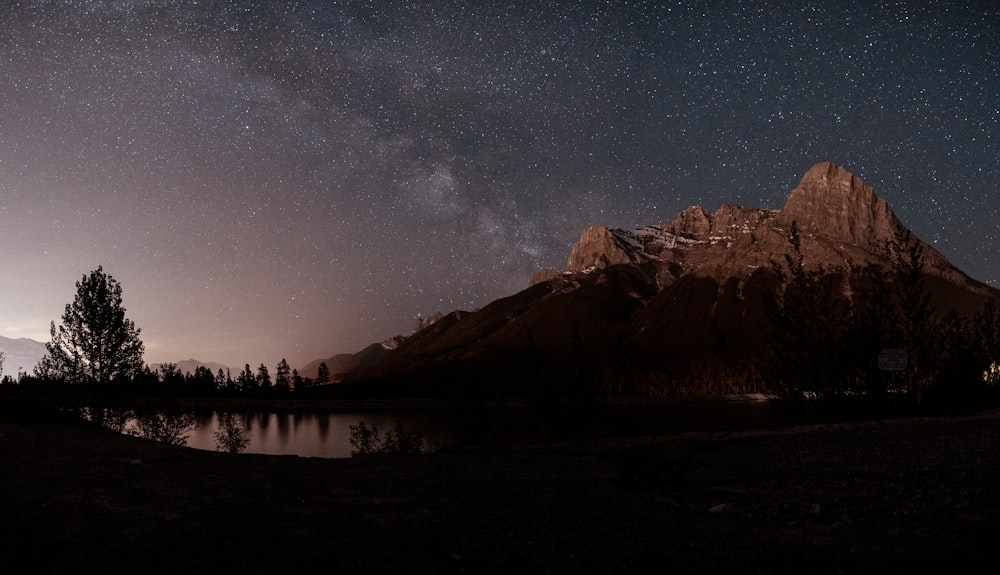 brown rocky mountain under starry night