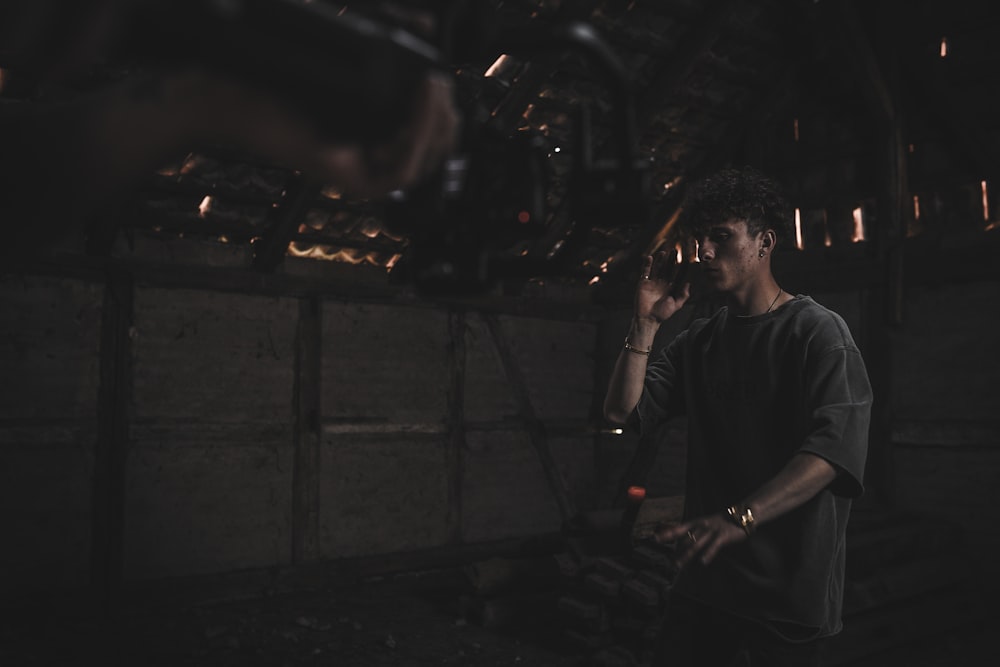 man in black crew neck t-shirt smoking cigarette