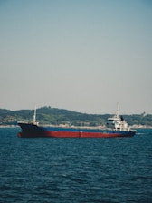 red and white ship on sea during daytime