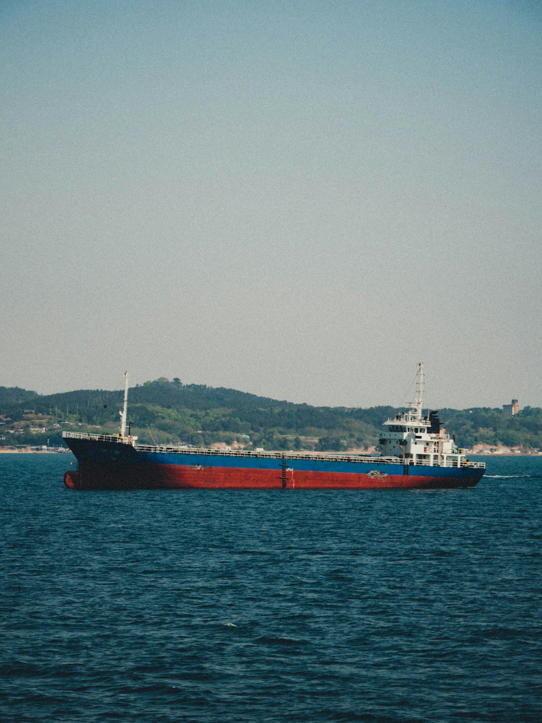 red and white ship on sea during daytime