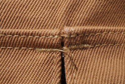 Close-up of detailed fabric textures and sewing craftsmanship on garments.