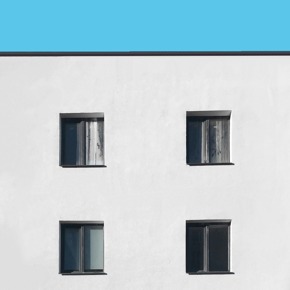 white concrete building with glass windows