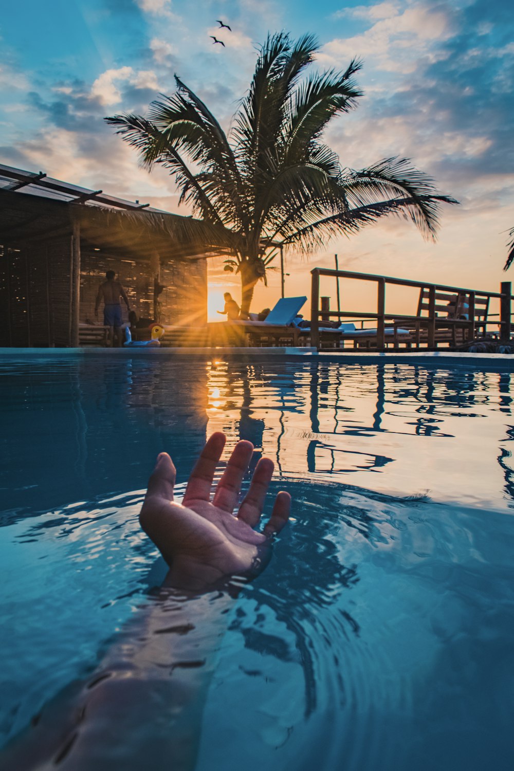 person lying on swimming pool during night time