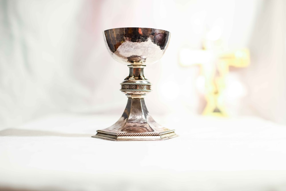 silver footed glass on white table