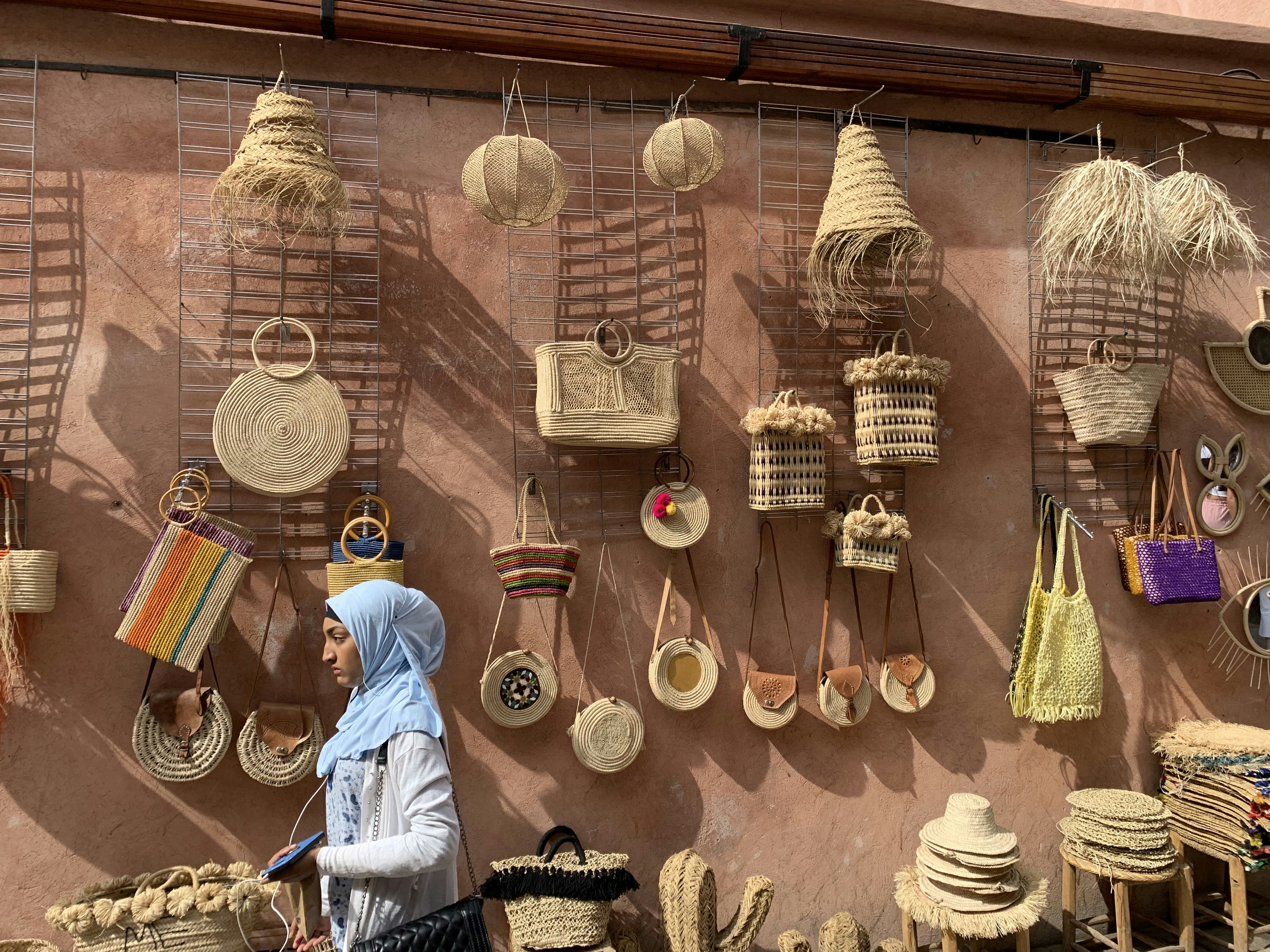 brown wooden hanging decor on brown wooden wall, Wall where handmade goods like baskets where presented for selling in Marrakech Médina.
