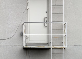 white metal window frame on gray concrete wall